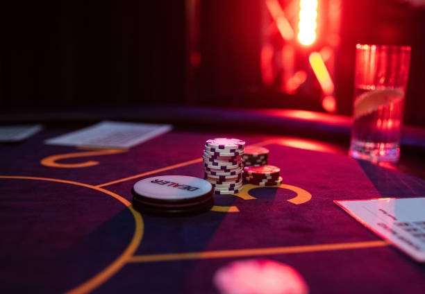 Live casino dealer at blackjack table with multi-camera setup